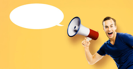 Very happy expressive man, sportsman sport coach in sportswear advertise use mega phone loudspeaker bullhorn, isolate yellow background. Sale ad concept. Free text space. Empty mockup speech bubble