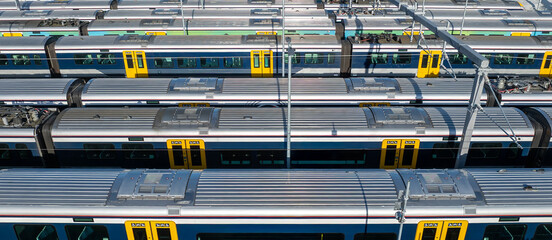 Commuter trains sit idle in a train yard in Auckland, New Zealand. The trains are awaiting their next assignment to transport passengers throughout the city.