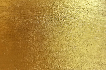 Gold Paint on Grunge Concrete Wall Texture Background.