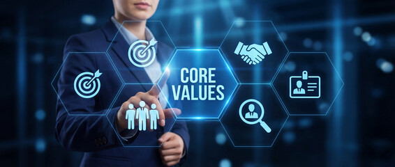 Obraz premium Businesswoman touching digital CORE VALUES interface with mission and teamwork icons. Concept of corporate ethics, organizational culture, and professional integrity in a modern office environment.
