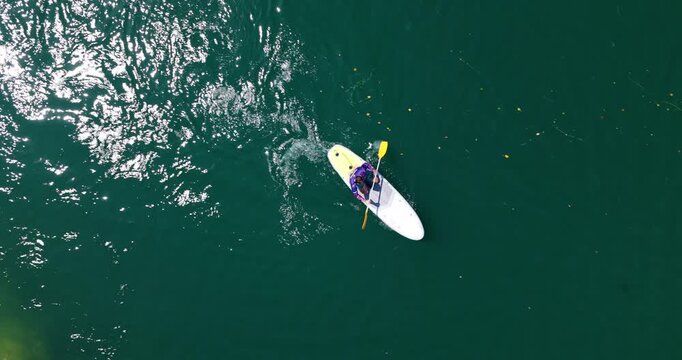 Overhead View Of Man Paddleboarding On Mreznica River In Summer in Croatia. - aerial shot