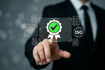 Businessman interacting with a futuristic virtual touchscreen interface to manage Quality Assurance and ISO certification. He is pointing at a glowing green badge with a checkmark, symbolizing approve