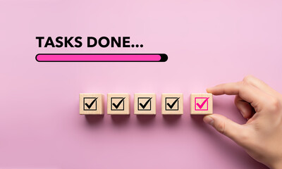 Completing Tasks Concept with Hand Placing Wooden Cube with Pink Checkmark, Task Completion and Progress on Light Pink Background