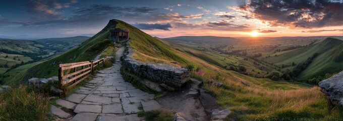 Panorama of a stone path winding across green hills under a colorful sunset sky