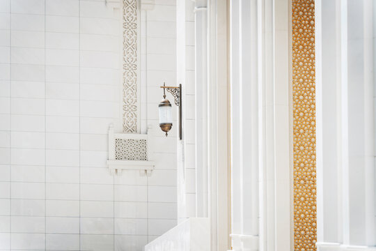 Ornate mosque wall and column detail with lantern in Dubai UAE