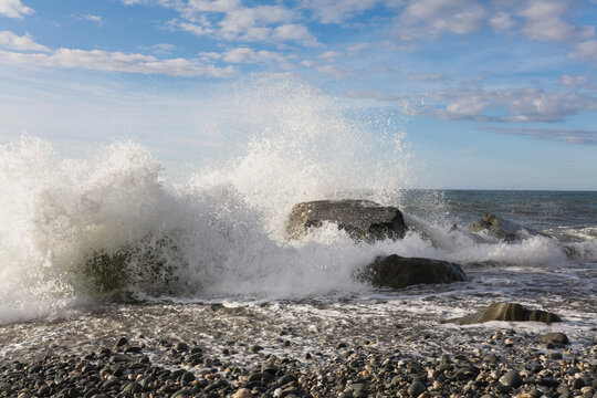 Waves crashing on rocks at Gillespies Beach Tasman Sea New Zealand
