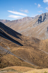 Winding mountain road and hiking trails leading to Big Almaty Peak. Summer trekking in Tien Shan mountains, Central Asia.