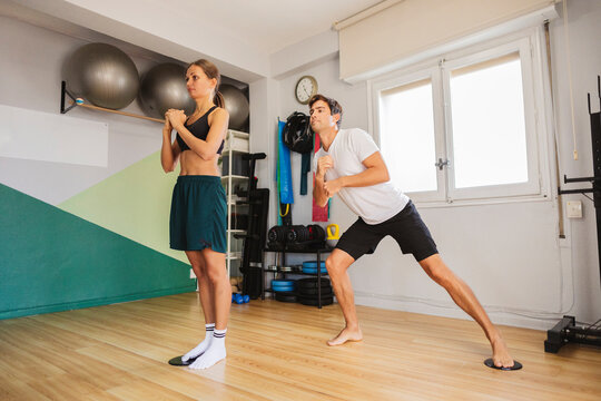 Athletic people exercising balance and resistance training indoors