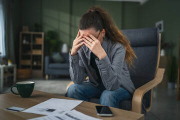 Stressed woman dealing with financial problems and debt at home