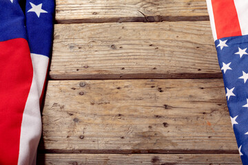 High angle view of usa flags with stars and stripes on wooden table with copy space