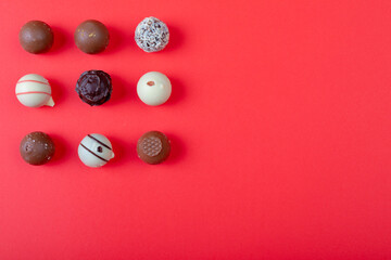Overhead view of dessert arranged on red background, copy space