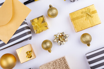Overhead view of christmas gifts and decoration arranged on white background, copy space