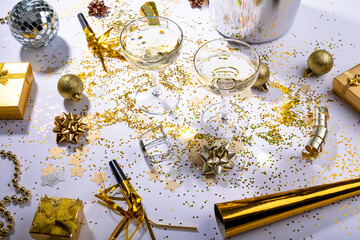 Champagne glasses with gold and silver colored decoration on table, copy space