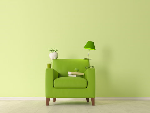 Green armchair with stacked objects symbolizing balance and relaxation
