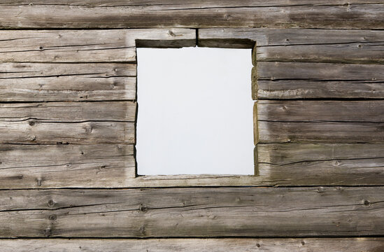 Closed window in weathered wooden house exterior Austria