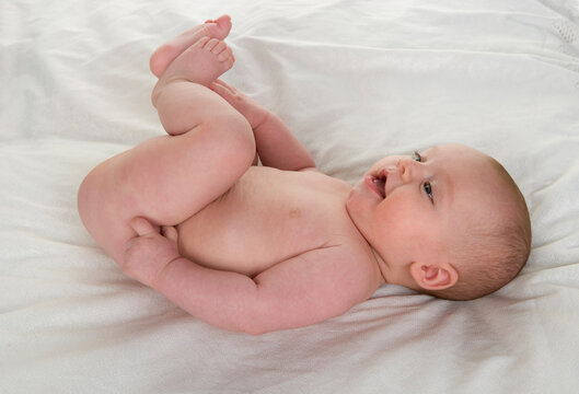 Smiling baby lying on blanket in studio portrait
