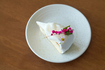 coconut cream cake, pink and purple flowers in white ceramic dish on wooden background, dessert, food, fashion, decor, copy space