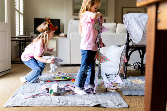 Young girl setting up the buntings around makeshift tent
