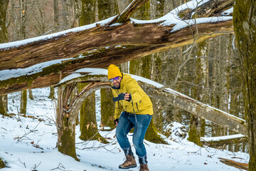 Man filming winter vlog in snowy forest