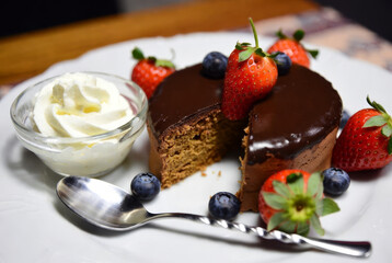 Chocolate cake with strawberries on a plate, a delicious dessert