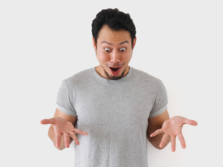 Man with a surprised expression on his face is wearing a gray shirt