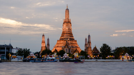 Stunning twilight view of Wat Arun temple along the Chao Phraya River in Bangkok, Thailand