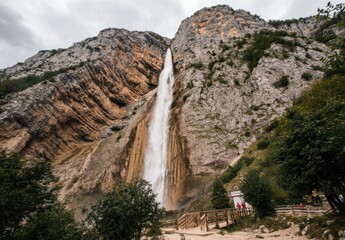 Majestic Waterfall Cascading Down a Rugged Mountain Face.