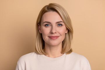 portrait of   blonde  woman on beige background 