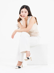 Portrait of attractive asian professional cheerful beautiful young woman in business work shirt style long black hair smile sitting posing happy confident positive on isolate white background studio.