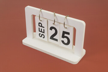 September 25 on calendar on brown background