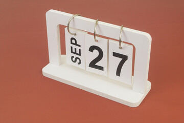 September 27 on calendar on brown background