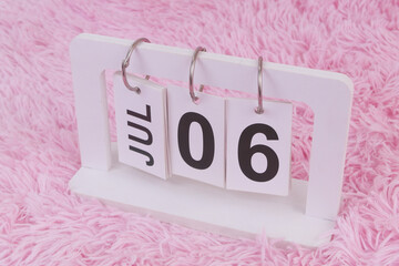 July 6 on calendar on pink carpet background