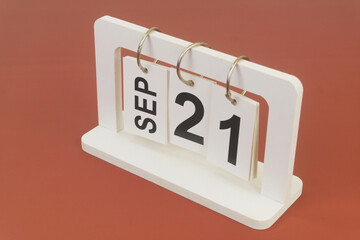 September 21 on calendar on brown background