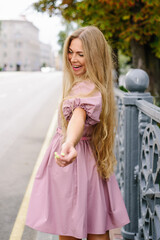 Fototapeta premium Joyful Young Woman In Pink Dress Outdoors