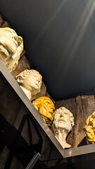 Clay Classical Heads in Sculptor's Workshop on Wooden Shelf. Aesthetic Artistic Mood Background