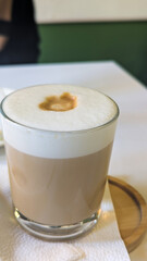 Closeup of Hot Latte or Cappuccino Drink in Caffe Interior in Green and Beige Tones. Still Life Restaurant Food Photography.