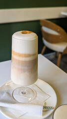 Closeup of Hot Latte or Cappuccino Drink in Caffe Interior in Green and Beige Tones. Still Life Restaurant Food Photography.