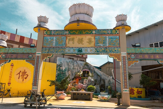 Traditional chinese gate with lotus flowers on top at the Buddhist temple in Pulau Ketam Malaysia