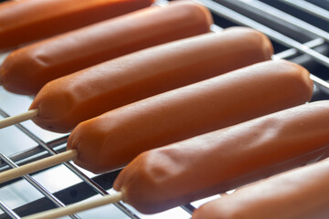 Pork sausage skewers on hot electric grill, Thai street food