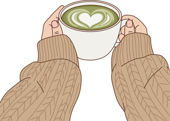 Cozy Hand Holding Hot Matcha Green Tea Latte with Heart Latte Art in White Cup Wearing Knitted Sweater