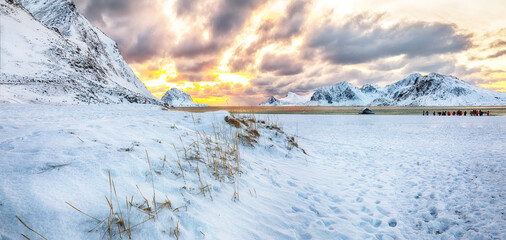 Amazing winter scenery with Haukland beach during sunset and snowy  mountain peaks near Leknes.