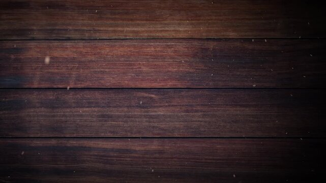 Warm detailed shot of dark brown wood grain with small particles floating for background use