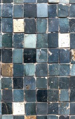 Blue white mosaic tiles showing weathering, creating distressed vintage surface with textural imperfections and aged visual characteristics