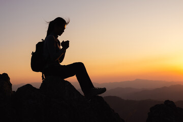 Silhouette of prayer woman worship God in the morning with sunrise sky background.  worship God...