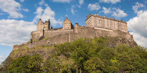 The panorama view of walls and towers of Edinburgh castle western defences with national war museum, cartsheds and new barracks taken from west Princes street gardens. Edinburgh, Scotland, UK © tracker
