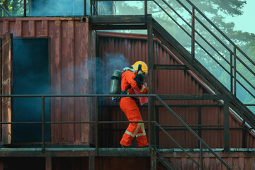 firefighter in an orange suit is walking down a metal staircase