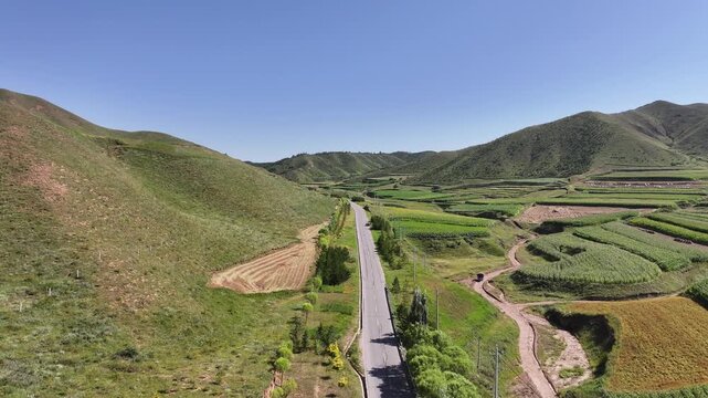 Agricultural Terraces and Road Through Gansu Valley Landscape