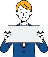 Smiling young businessman with blond hair in a blue suit holding a blank white sign.