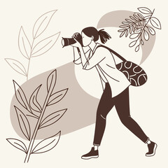 Fototapeta premium A woman captures the beauty of nature through her camera lens while walking outdoors