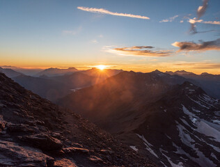 Sunset from Rocciamelone mountain peak in Graian Alps in Italy near borders with France
